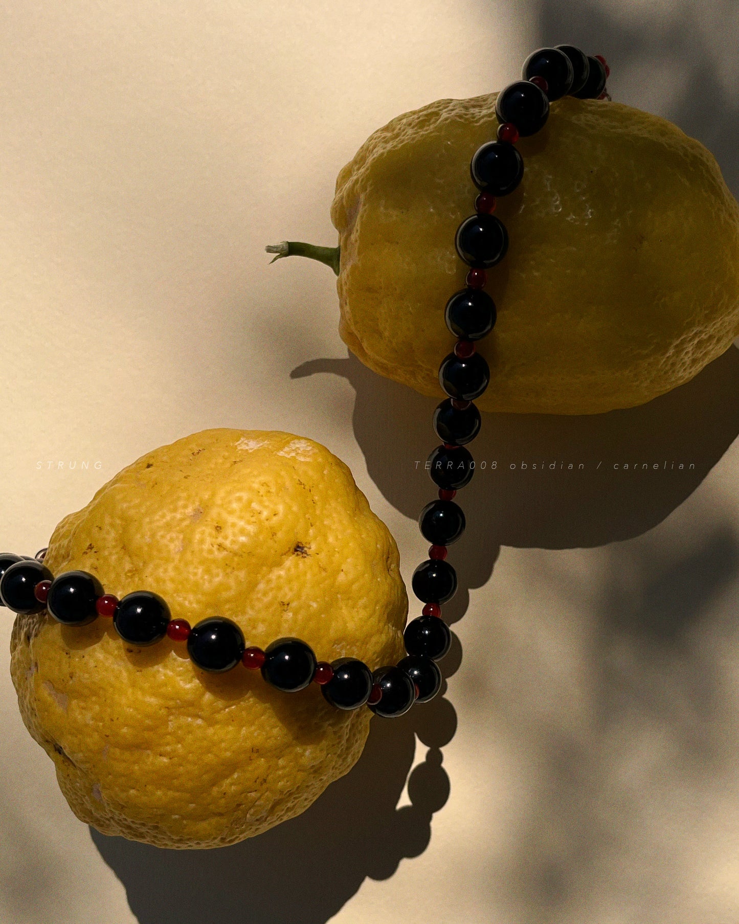 Obsidian and carnelian beads strung in grounding, vibrant contrast