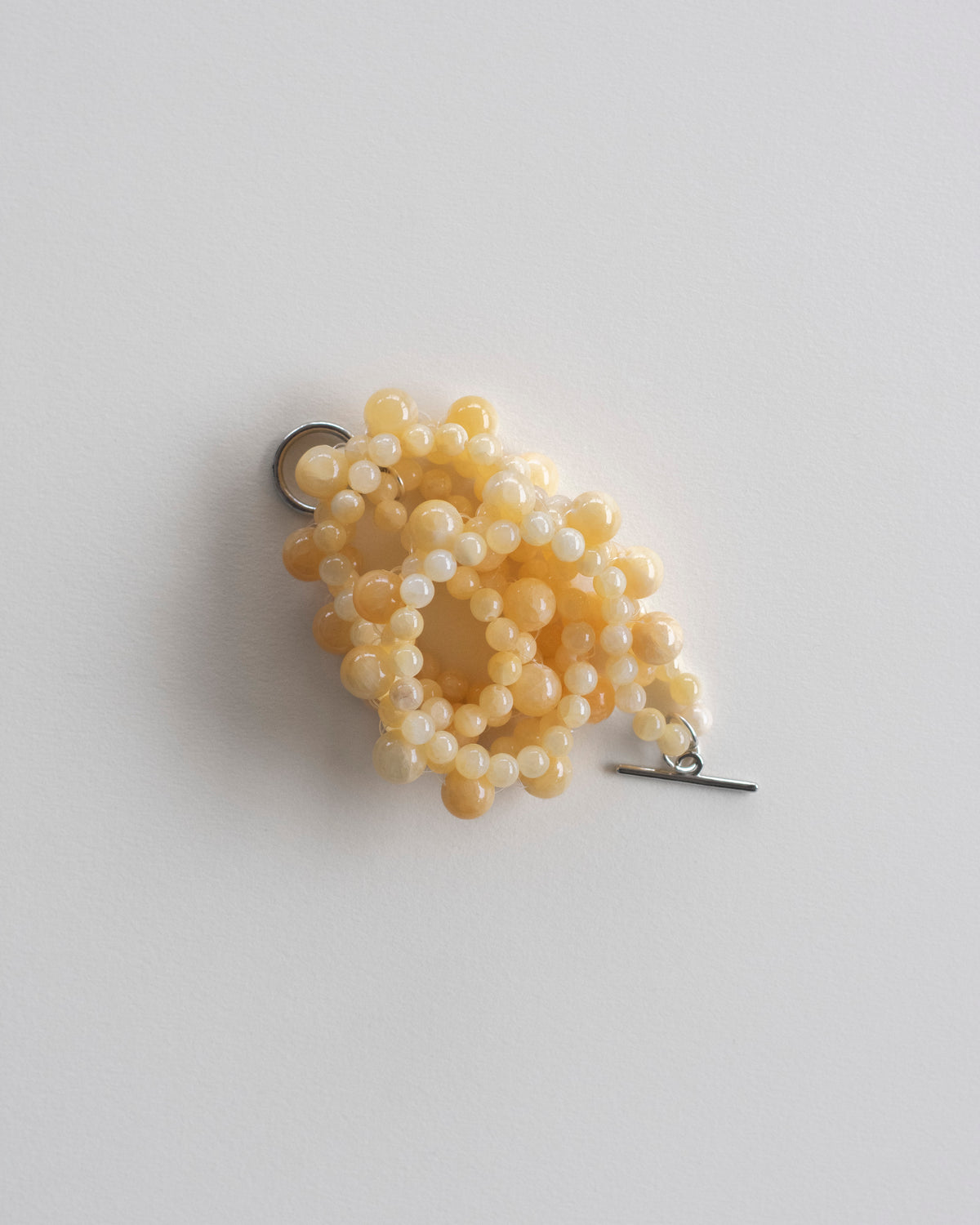 Yellow honey jade beaded necklace on a light gray background