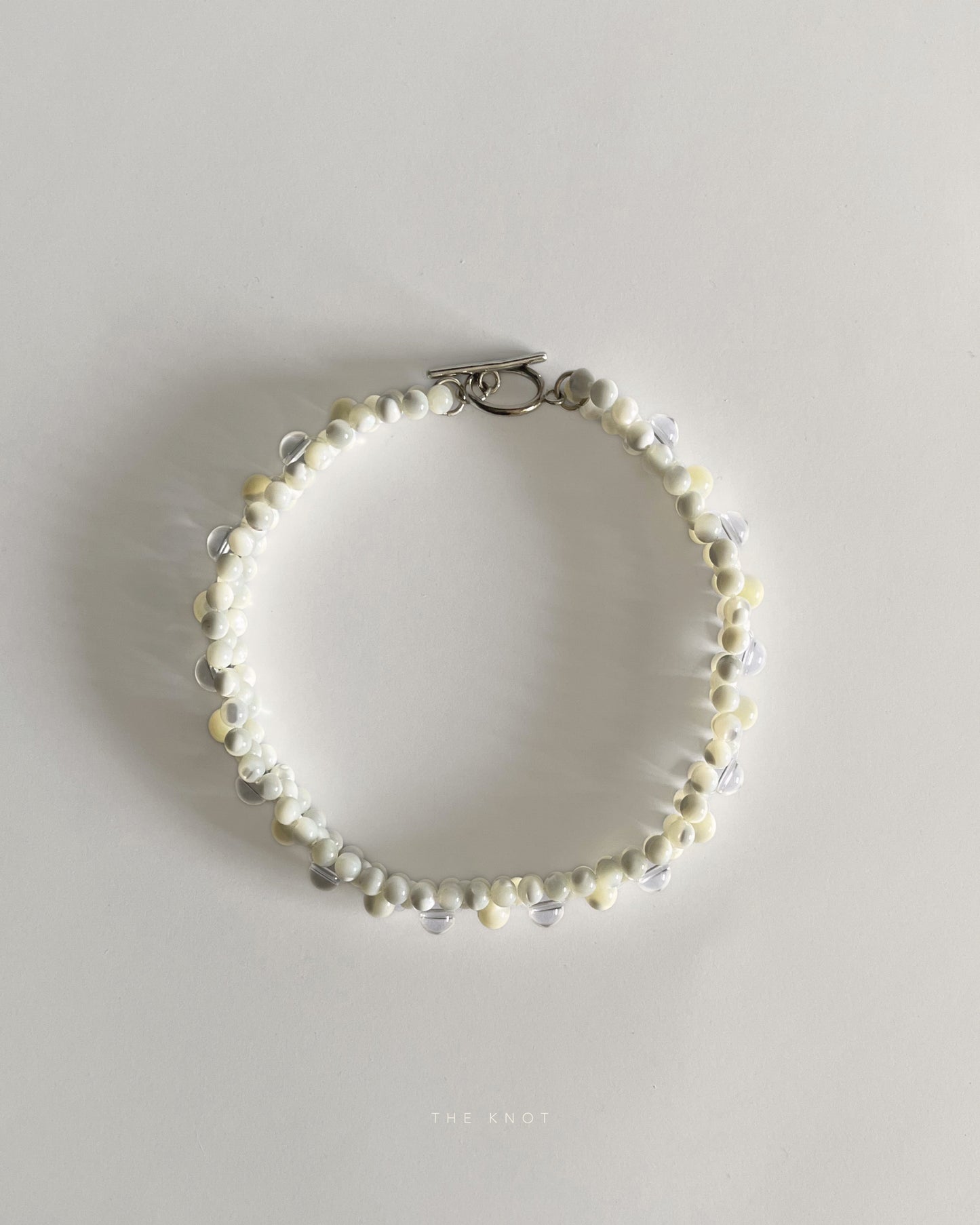 top view of hand-strung mother of pearl and crystal quartz double layered beaded necklace