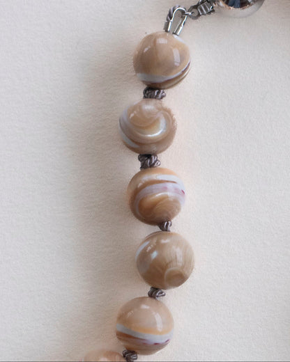 detail of mother of Pearl hand-knotted necklace on grey silk with 925 sterling silver clasp