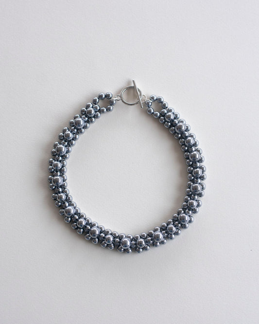 Silver hematite beaded choker necklace, on a light gray background