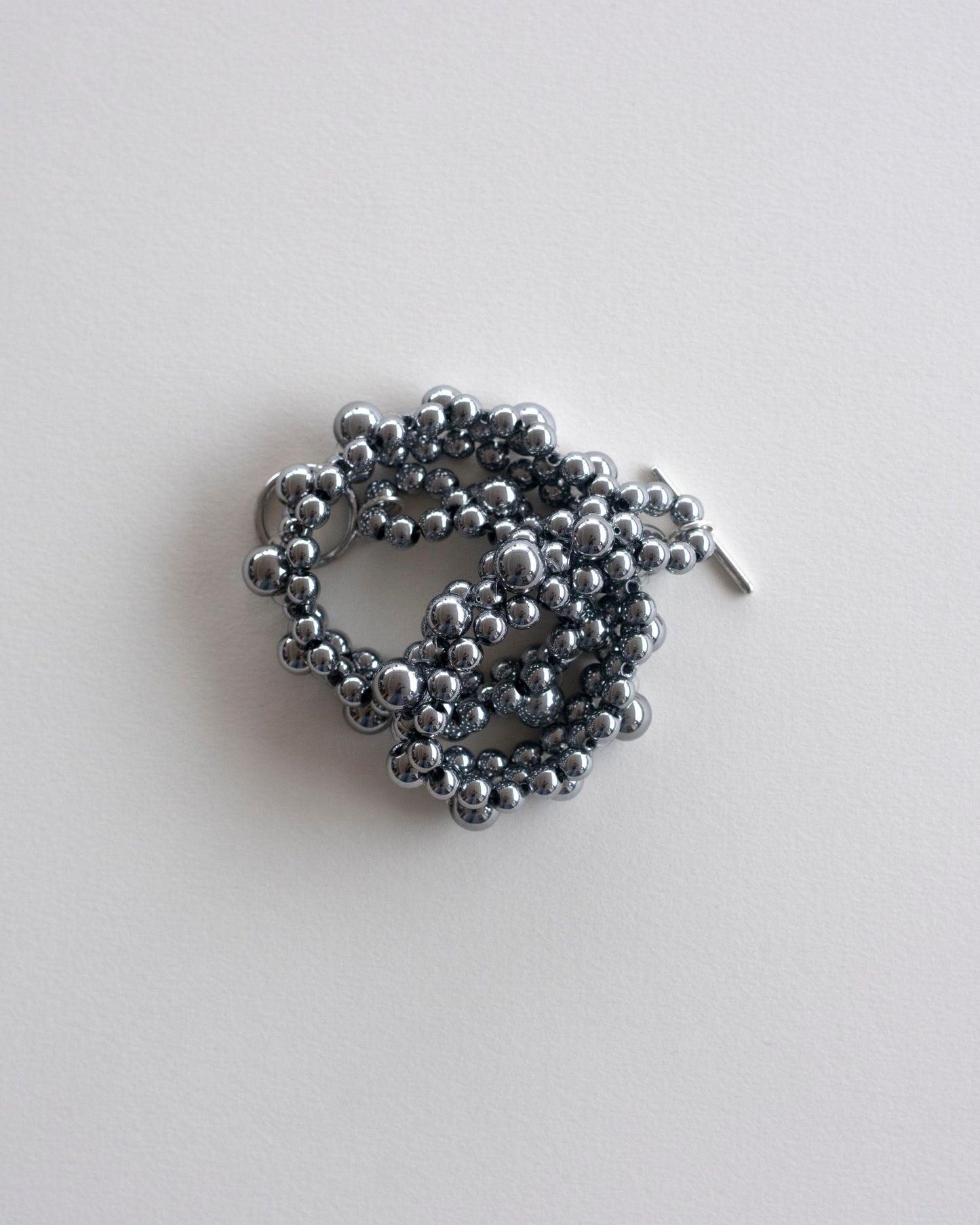 Silver hematite beaded choker necklace, on a light gray background