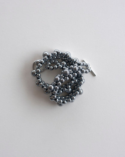 Silver hematite beaded choker necklace, on a light gray background
