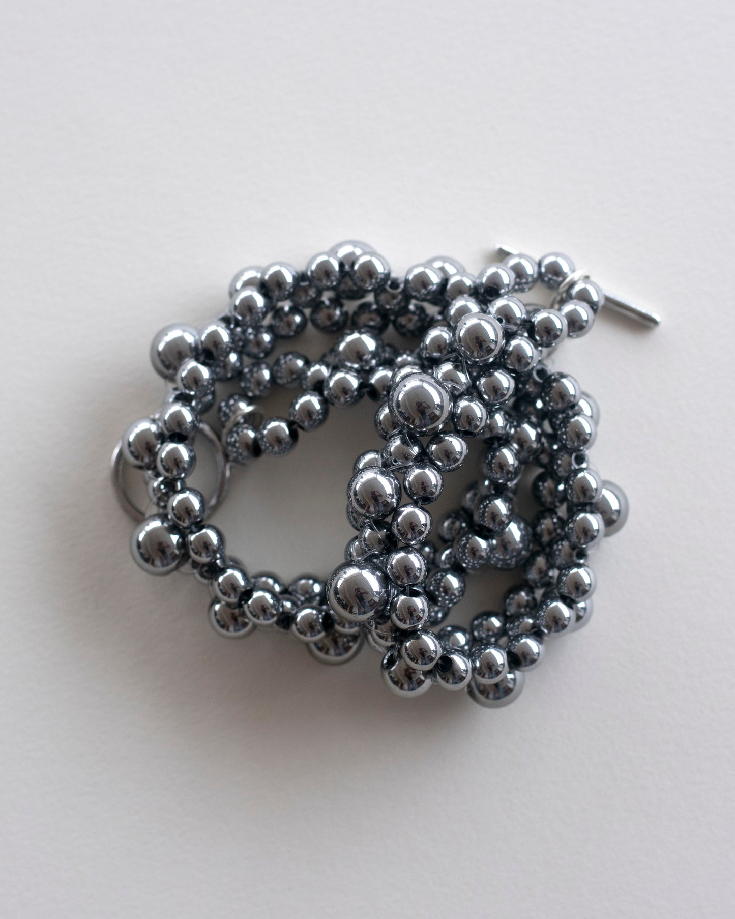 Silver hematite beaded choker necklace, on a light gray background