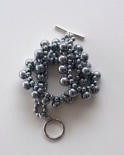 Silver hematite beaded choker on a light gray background