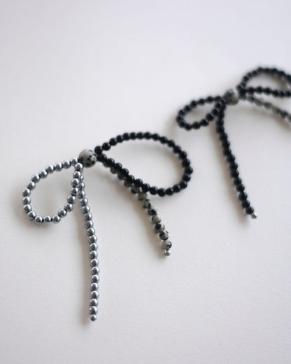 beaded bow earrings made in hematite, dalmatian jasper and onyx