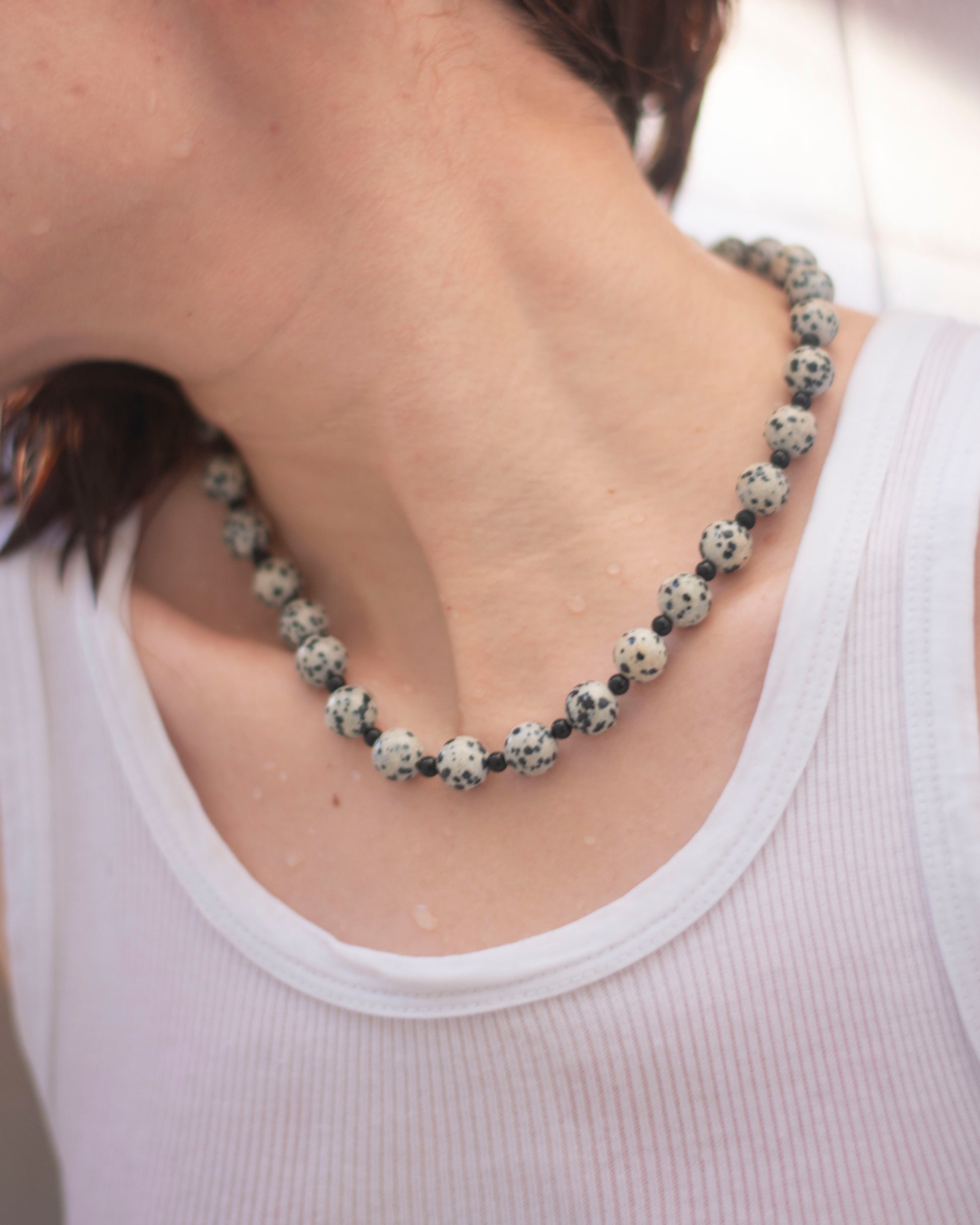 model wearing dalmatian jasper and onyx beaded necklace
