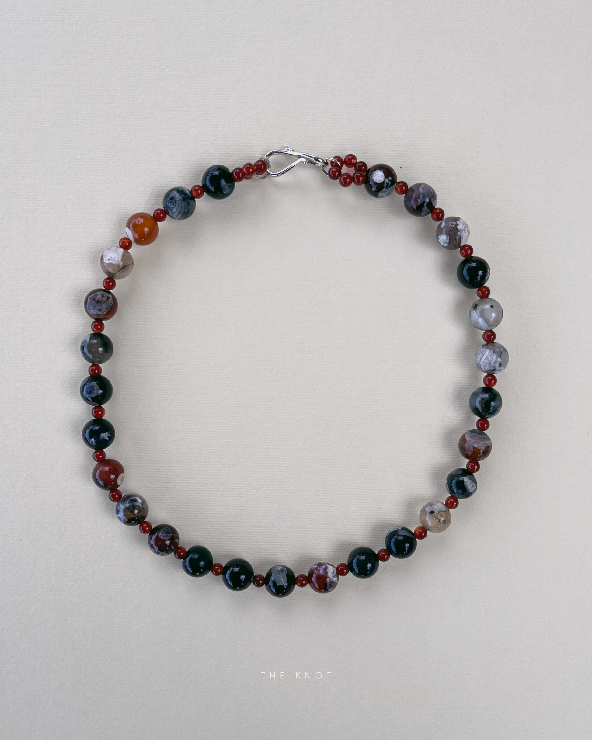 TERRA005 gemstone necklace featuring warm reds and intricate patterns of fire lace agate paired with fiery carnelian on silk thread.