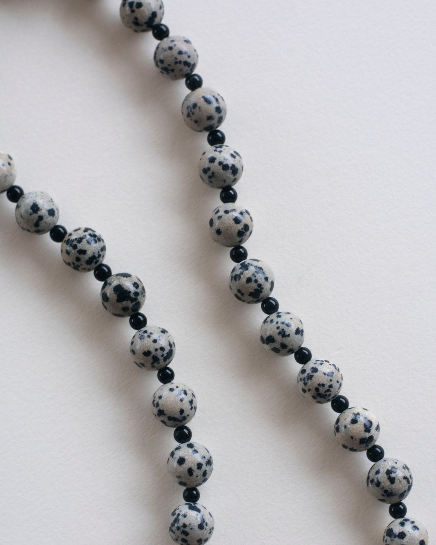 close up of dalmatian jasper and onyx beaded necklace