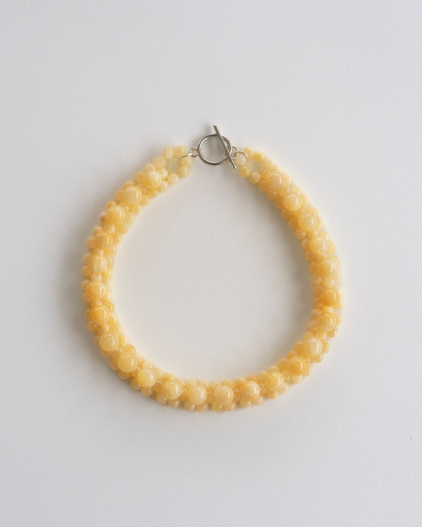 honey jade beaded necklace on a light gray background