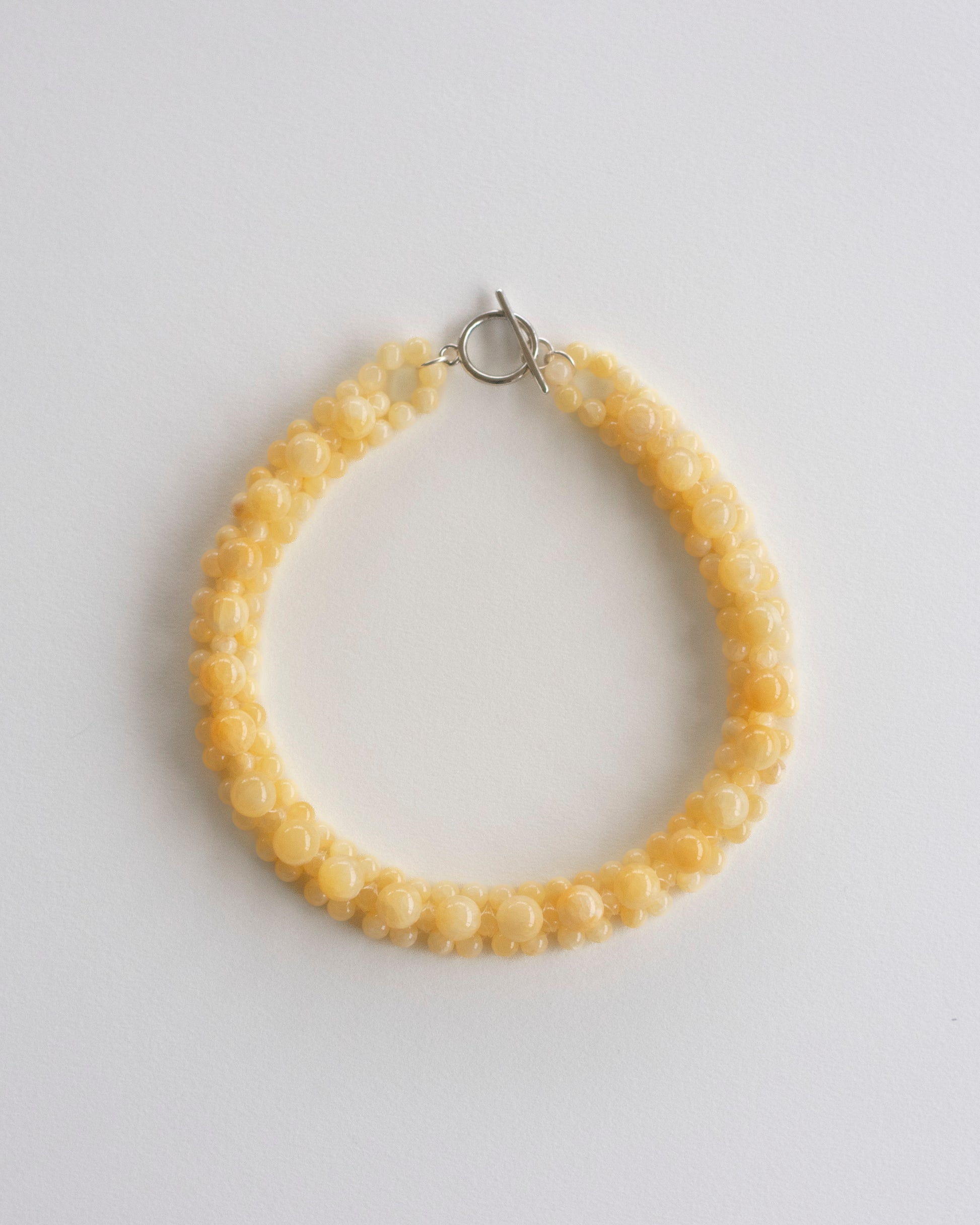 honey jade beaded necklace on a light gray background