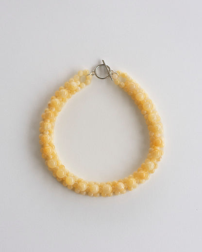 honey jade beaded necklace on a light gray background