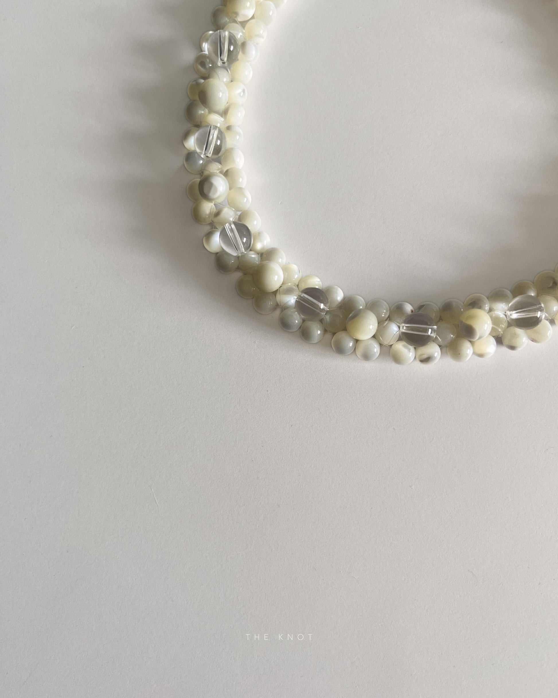 detail of handmade and ethically sourced mother of pearl and crystal quartz double layered beaded necklace