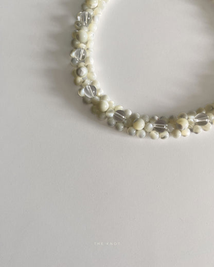 detail of handmade and ethically sourced mother of pearl and crystal quartz double layered beaded necklace