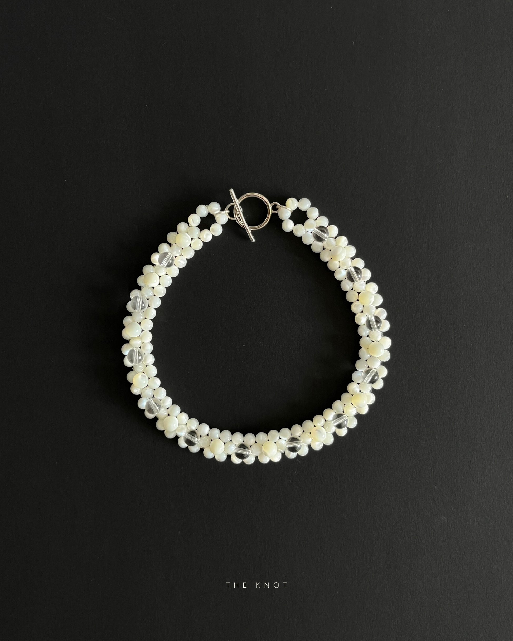mother of pearl and crystal quartz double layered beaded necklace, handmade, ethically sourced. front black background