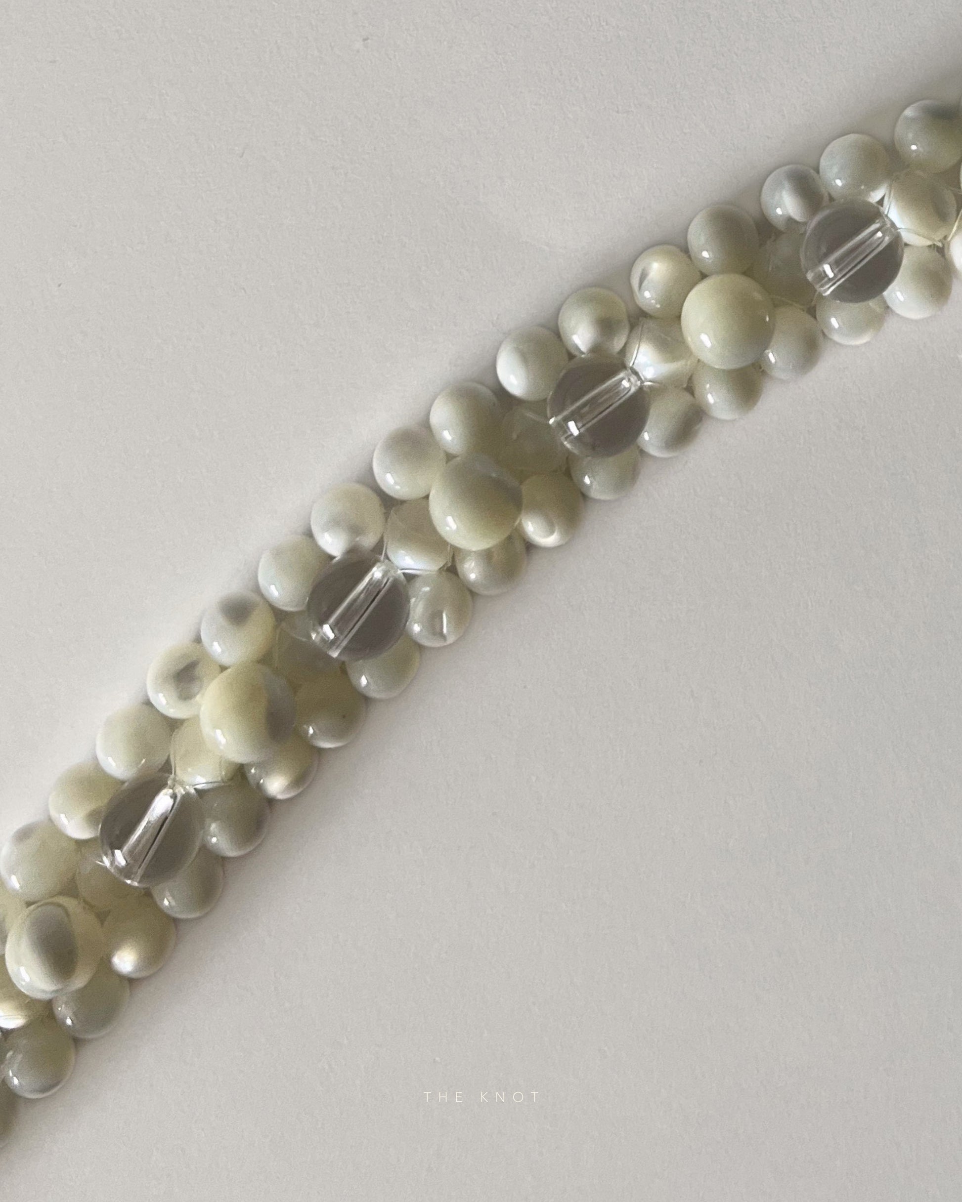 close up of mother of pearl and crystal quartz double layered beaded necklace front