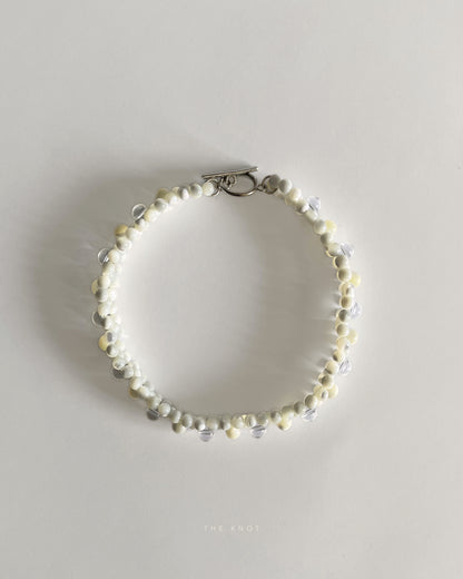 top view of hand-strung mother of pearl and crystal quartz double layered beaded necklace 