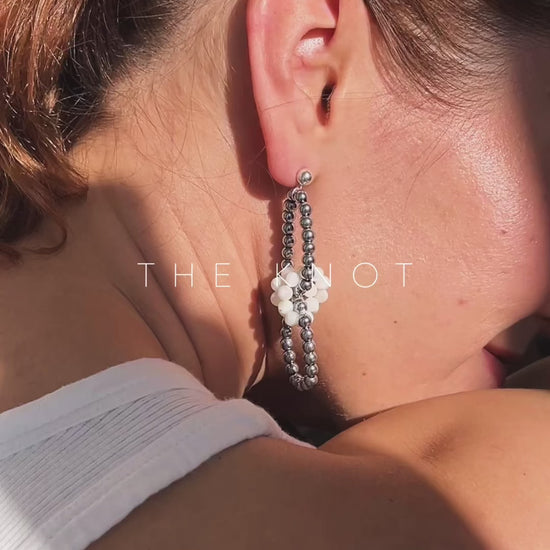model wearing hematite and mother of pearl link earrings