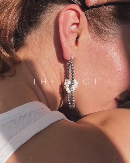model wearing hematite and mother of pearl link earrings
