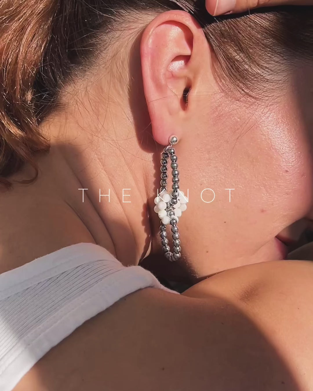 model wearing hematite and mother of pearl link earrings